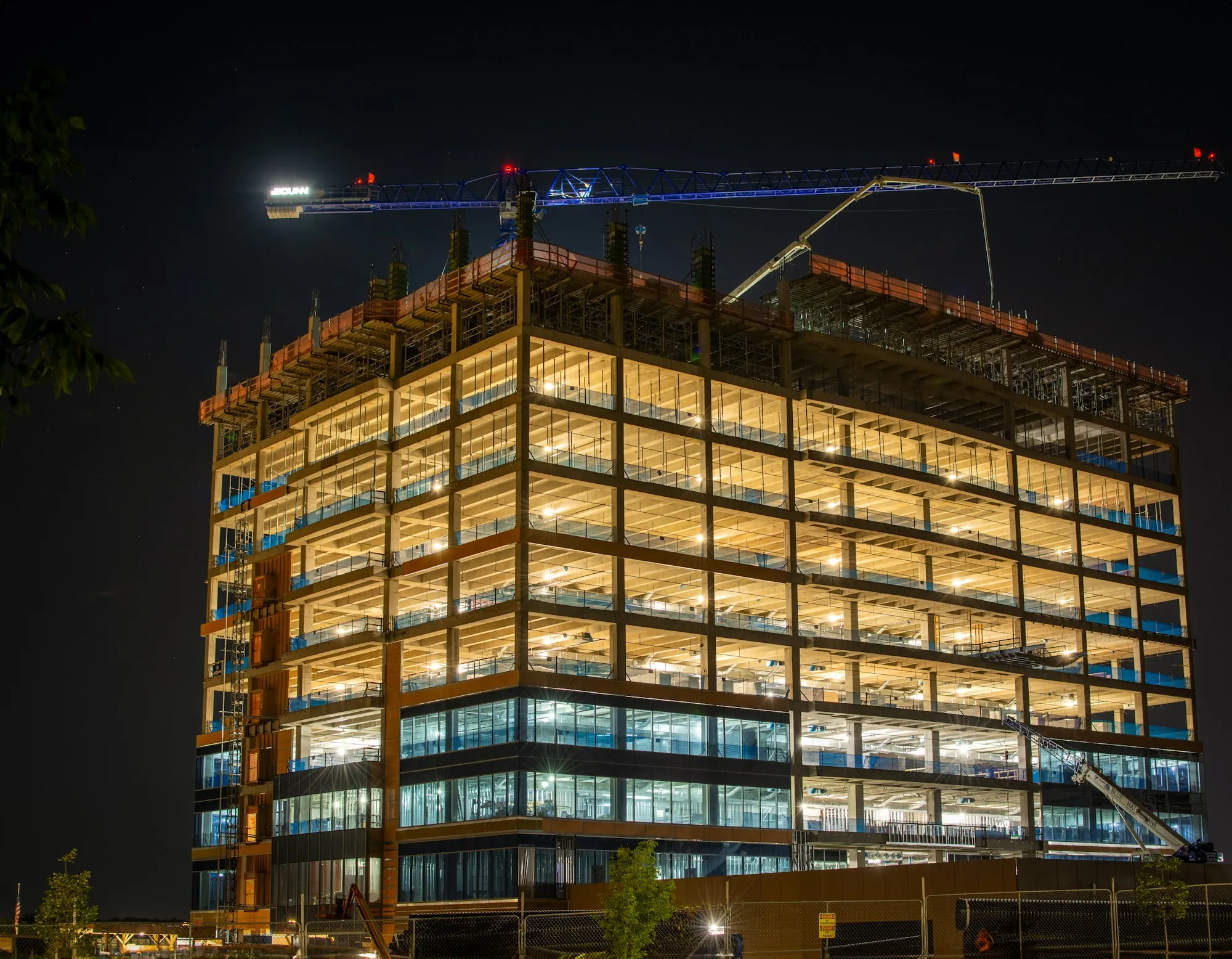 Building lit up at night during construction